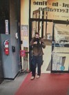 In this image taken from video released by the Androscoggin County Sheriff's Office, an unidentified shooter points a gun while entering Sparetime Recreation in Lewiston, Maine, on Wednesday, Oct. 25, 2023. Maine State Police ordered residents in the state's second-largest city to shelter in place Wednesday night as the suspect remains at large. (Androscoggin County Sheriff's Office via AP)