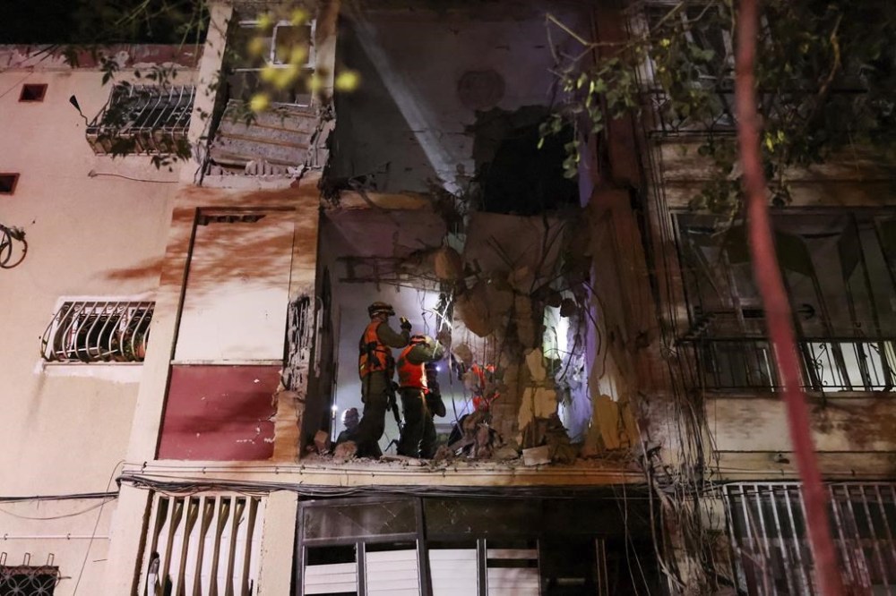 Israeli soldiers inspect the damage of a residential building after it was hit by a rocket fired from the Gaza Strip, in Rishon Lezion, Israel, Wednesday, Oct. 25, 2023. (AP Photo/Tomer Appelbaum)