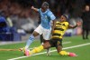 Manchester City's Jeremy Doku, left, and YB's Ulisses Garcia vie for the ball, during the Champions League group G soccer match between BSC Young Boys and Manchester City, at the Wankdorf stadium, in Bern, Switzerland, Wednesday, Oct. 25, 2023. (Peter Klaunzer/Keystone via AP)