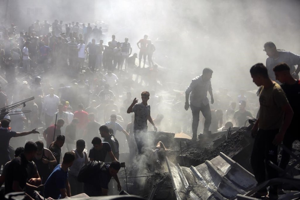 Palestinians inspect the rubble of destroyed buildings following Israeli airstrikes on the town of Khan Younis, southern Gaza Strip, Thursday, Oct. 26, 2023. As the fifth Israel-Hamas war rages, growing more deadly and devastating, international and local monitoring groups in besieged Gaza have been unable to keep up. (AP Photo/Mohammed Dahman)