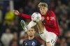Manchester United's Alejandro Garnacho, top, duels for the ball with Copenhagen's Peter Ankersen during the Champions League group A soccer match between Manchester United and Copenhagen at the Old Trafford stadium in Manchester, England, Tuesday, Oct. 24, 2023. (AP Photo/Dave Thompson)