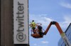 FILE - A workman removes a character from a sign on the Twitter headquarters building in San Francisco, July 24, 2023. One year ago, Elon Musk began transforming the social media platform into what is now known as X. (AP Photo/Godofredo A. Vásquez, File)