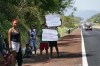 Residents hold help signs that read in Spanish 