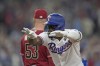 Texas Rangers' Adolis Garcia celebrates after hitting an RBI single against the Arizona Diamondbacks during the first inning in Game 1 of the baseball World Series Friday, Oct. 27, 2023, in Arlington, Texas. (AP Photo/Godofredo A. Vásquez)