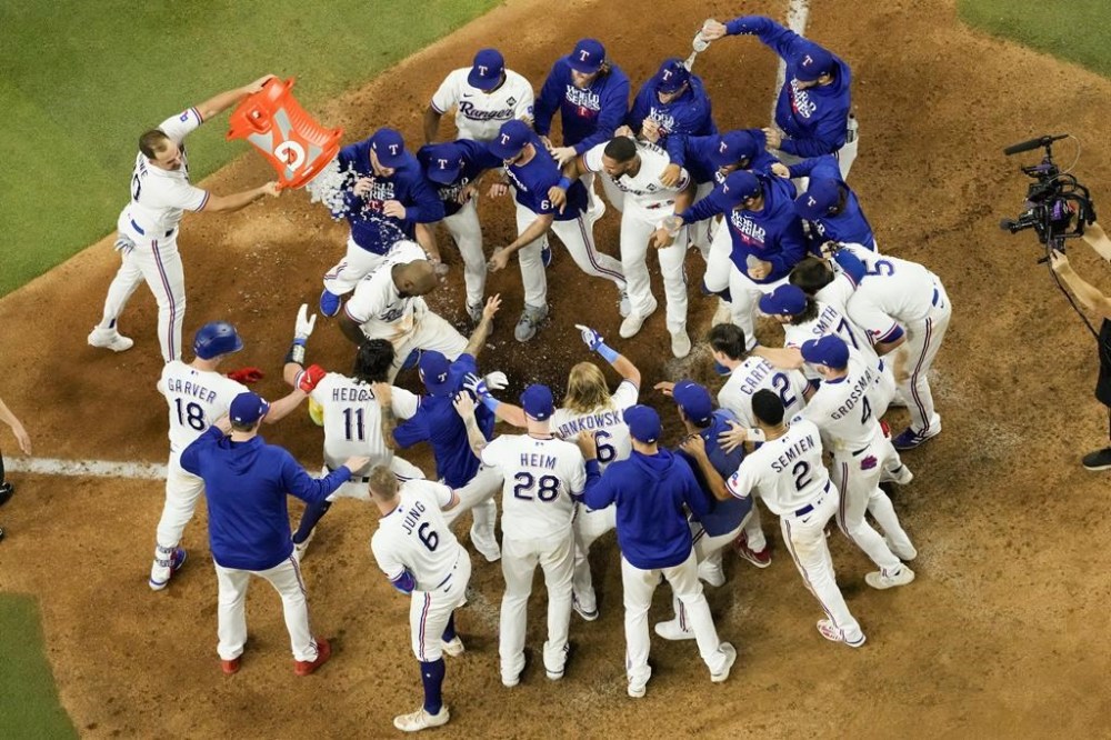 Texas Rangers' Adolis Garcia celebrates after hitting a game-winning home run against the Arizona Diamondbacks during the 11th inning in Game 1 of the baseball World Series Friday, Oct. 27, 2023, in Arlington, Texas. The Rangers won 6-5. (AP Photo/Godofredo A. Vásquez)
