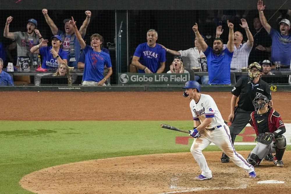 Texas Rangers' Corey Seager celebrates his two run home run off Arizona Diamondbacks relief pitcher Paul Sewald during the ninth inning in Game 1 of the baseball World Series Friday, Oct. 27, 2023, in Arlington, Texas. (AP Photo/Tony Gutierrez)