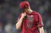 Arizona Diamondbacks relief pitcher Paul Sewald walks to the dugout after giving up two runs the Texas Rangers in the ninth inning in Game 1 of the baseball World Series Friday, Oct. 27, 2023, in Arlington, Texas. (AP Photo/Brynn Anderson)