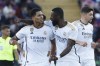Real Madrid's Jude Bellingham, left, celebrates with Real Madrid's Antonio Rudiger, centre, after scoring his side's opening goal during the La Liga soccer match between Barcelona and Real Madrid at the Olympic Stadium in Barcelona, Spain, Saturday, Oct. 28, 2023. (AP Photo/Joan Monfort)