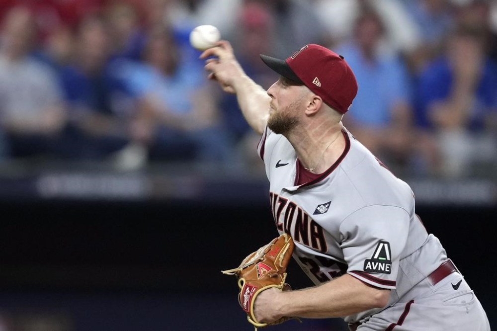 Arizona Diamondbacks starting pitcher Merrill Kelly throws against the Texas Rangers during the fourth inning in Game 2 of the baseball World Series Saturday, Oct. 28, 2023, in Arlington, Texas. (AP Photo/Godofredo A. Vásquez)