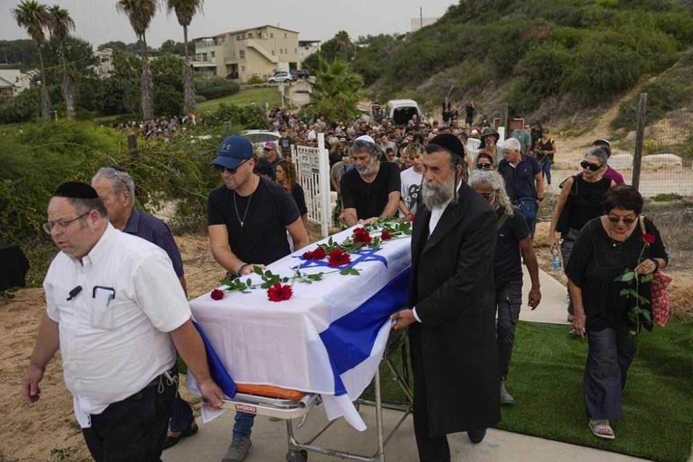 Friends and relatives of Yonat Or carry her coffin during her funeral at Kibbutz Palmachim, Israel, Sunday, Oct. 29, 2023. Or was killed by Hamas militants on Oct. 7, in Kibbutz Be'eri near the border with the Gaza Strip. More than 1,400 people were killed and some 220 captured in an unprecedented, multi-front attack on Israel by the militant group that rules Gaza. (AP Photo/Ariel Schalit)