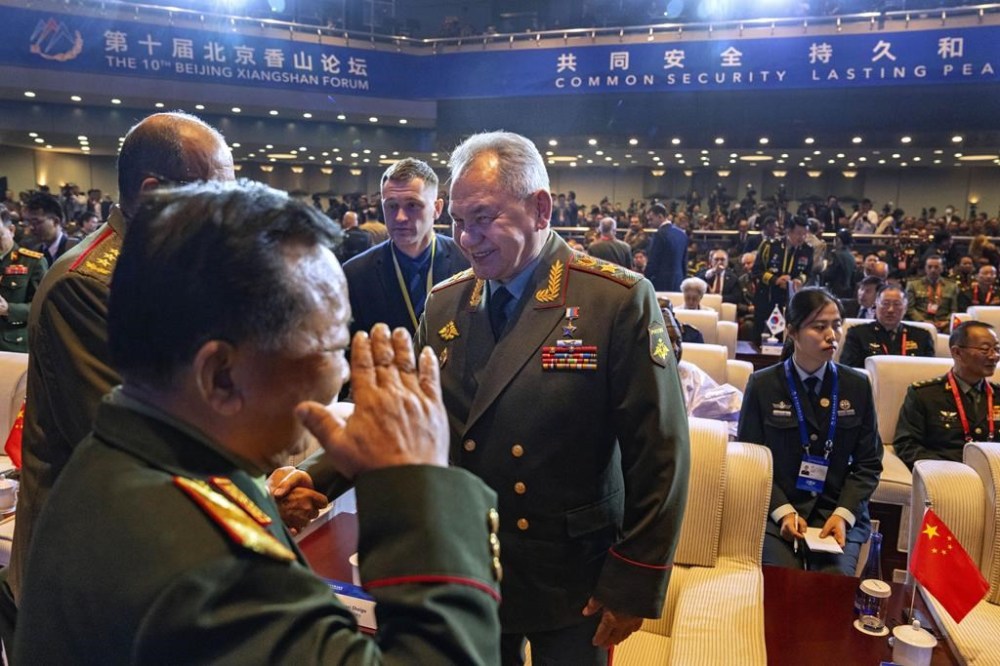 Russian Defense Minister Sergei Shoigu, center, chats with other attendees as he arrives for the opening ceremony of the 10th Beijing Xiangshan Forum in Beijing, Monday, Oct. 30, 2023. Defense Minister Shoigu said Monday the United States is fueling geopolitical tensions to uphold its