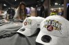 A Chase Field Arizona Diamondbacks team shop employee restocks Diamondbacks World Series baseball hats at Chase Field Wednesday, Oct. 25, 2023, in Phoenix. The Diamondbacks will face the Texas Rangers in Game 1 of the World Series on Friday. (AP Photo/Ross D. Franklin)
