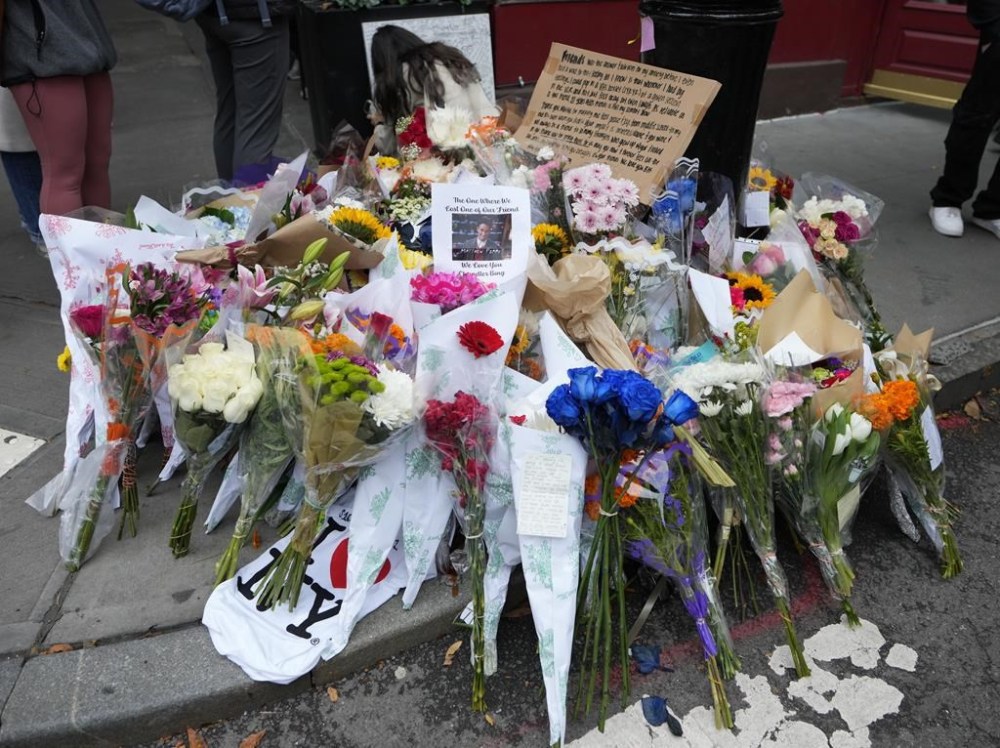 A makeshift memorial for Matthew Perry is seen outside the building shown in exterior shots of the television show