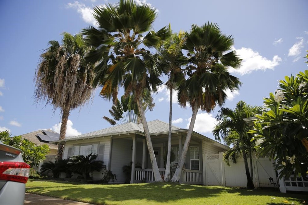 FILE - The home where U.S. defense contractor Walter Glenn Primrose and his wife, Gwynn Darle Morrison, lived for years allegedly under aliases, is pictured on July 27, 2022, in Kapolei, Hawaii. A jury has convicted a Hawaii couple of conspiracy, passport fraud and identity theft during a trial over allegations of that they lived for decades using names of dead babies. According to court records, jurors deliberated for about two hours before reaching guilty verdicts Monday, Oct. 30, 2023. (AP Photo/Caleb Jones, File)
