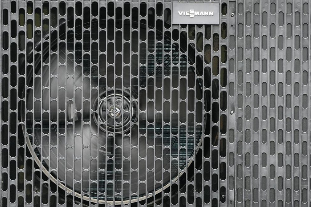 The federal government has ramped up financial support to help transition homeowners away from oil furnaces — the most expensive way to heat a home — to heat pumps instead. A heat pump works outside a Viessmann distribution centre in Castrop-Rauxel, Germany, Wednesday, April 26, 2023. THE CANADIAN PRESS/AP-Martin Meissner