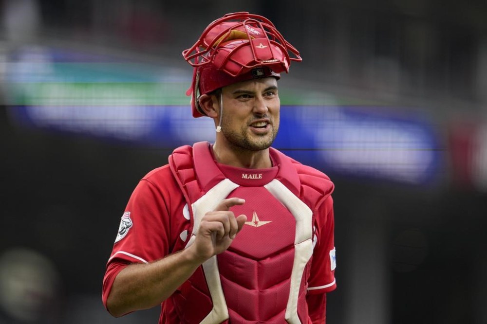 FILE -Cincinnati Reds catcher Luke Maile gestures during a baseball game against the Cleveland Guardians in Cincinnati, Wednesday, Aug. 16, 2023. Catcher Luke Maile is guaranteed $3.5 million under his one-year contract with the Cincinnati Reds, which prevented him from becoming a free agent after the World Series.(AP Photo/Jeff Dean, File)