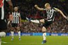 Newcastle's Lewis Hall scores his side's second goal during the EFL Cup fourth round soccer match between Manchester United and Newcastle at Old Trafford stadium in Manchester, England, Wednesday, Nov. 1, 2023. (AP Photo/Dave Thompson)