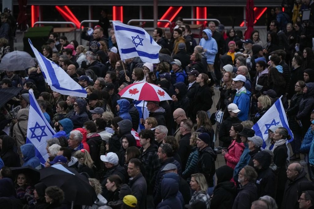 People attend a vigil organized by the Jewish Federation of Greater Vancouver in support of those killed in Israel, in Vancouver, on Tuesday, Oct. 10, 2023. THE CANADIAN PRESS/Darryl Dyck