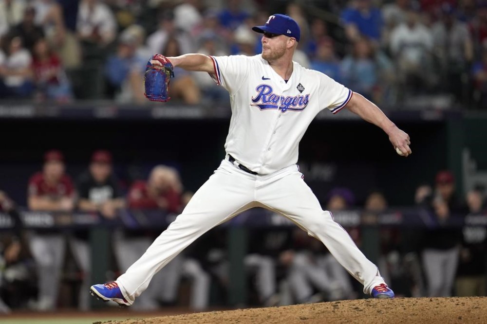 Texas Rangers relief pitcher Will Smith throws against the Arizona Diamondbacks during the ninth inning in Game 1 of the baseball World Series Friday, Oct. 27, 2023, in Arlington, Texas. (AP Photo/Godofredo A. Vásquez)
