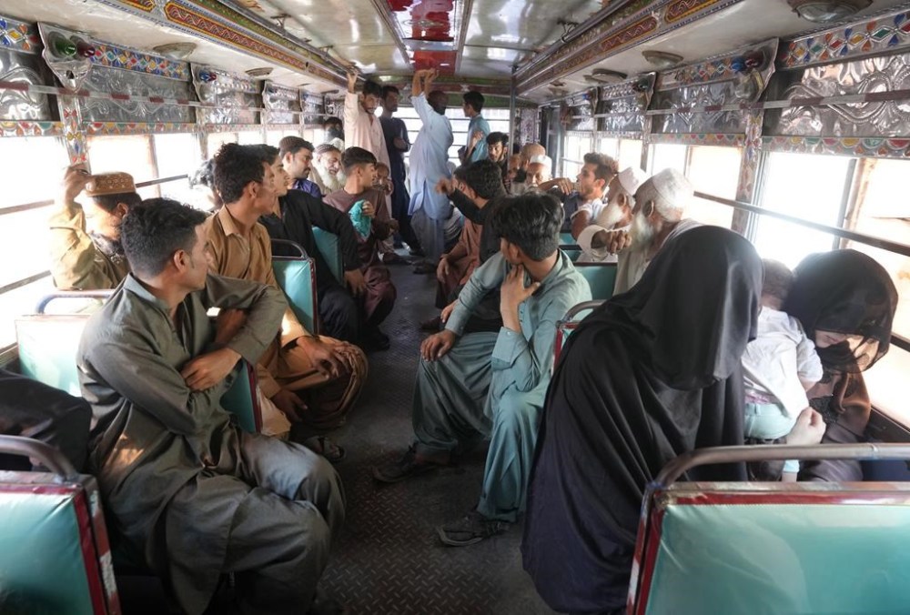 Detained immigrants, who fail to provide legal documents, are transported by police in a bus to shift them in a deportation center in Karachi, Pakistan, Thursday, Nov. 2, 2023. Pakistani security forces rounded up, detained and deported dozens of Afghans who were living in the country illegally, after a government-set deadline for them to leave expired, authorities said. (AP Photo/Fareed Khan)