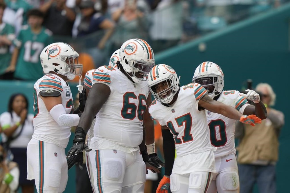 Miami Dolphins wide receiver Jaylen Waddle (17) celebrates with teammates after scoring a touchdown during the second half of an NFL football game against the New England Patriots, Sunday, Oct. 29, 2023, in Miami Gardens, Fla. (AP Photo/Lynne Sladky)