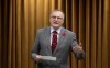 NDP House Leader Peter Julian rises during Question Period, Friday, October 27, 2023 in Ottawa. The New Democrats are breaking with the Liberals and their own support of carbon pricing to back the Conservatives on a motion to pull the carbon price off all home heating until after the next election. THE CANADIAN PRESS/Adrian Wyld