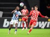 Hertha's Deyovaisio Zeefuik, left, against Mainz's Brajan Gruda battle for the ball during their German Soccer Cup second round soccer match at the Olympiastadion in Berlin, Wednesday, Nov. 1, 2023. (Soeren Stache/dpa via AP)