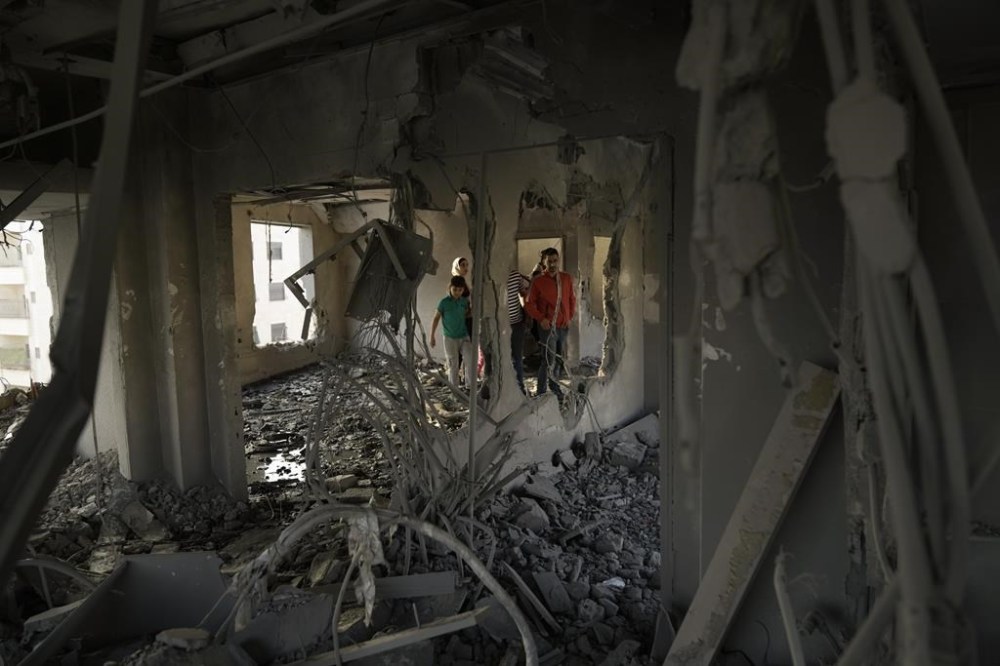 Palestinians look at the apartment of Khaled Kharousha that was destroyed by the Israeli military in Nablus, West Bank, Friday, Nov. 3, 2023. Israel's High Court of Justice gave the army the go-ahead to destroy Kharousha's apartment, who is suspected of helping his father kill two Israelis in Huwara earlier this year. (AP Photo/Majdi Mohammed)
