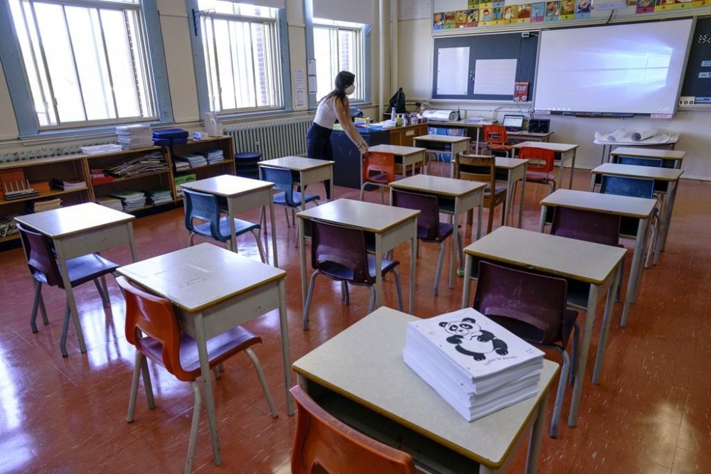 A Grade 1 teacher arranges the desks in preparation for the new school year at the Willingdon Elementary School, in Montreal, on Aug. 26, 2020. THE CANADIAN PRESS/Paul Chiasson