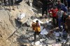 FILE - A Palestinian man carries a dead child that was found under the rubble of a destroyed building, following Israeli airstrikes in Jabaliya refugee camp, northern Gaza Strip, Wednesday, Nov. 1, 2023. Weeks after ordering northern Gaza's 1.1 million inhabitants to evacuate south, the Israeli army is intensifying its bombing of the area that stretches to the wetlands of Wadi Gaza. Israeli soldiers are also battling Hamas militants just north of Gaza City. It's the start of what officials expect to be a long and bloody invasion that has already pinned down hundreds of thousands of Palestinians who remain in the north. (AP Photo/Abed Khaled, File)