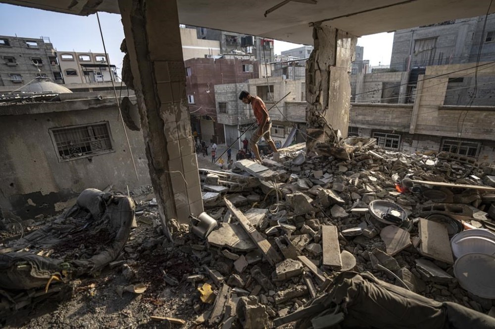 Palestinians look at the destruction after Israeli strikes on the Gaza Strip in Khan Younis, Friday, Now. 3, 2023. (AP Photo/Fatima Shbair)