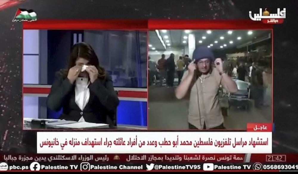 This video grab shows Palestine TV correspondent Salman Al-Bashir, right, removing his flak jacket and helmet on air during his reporting from Nasser Hospital in the southern Gaza Strip late on Thursday Nov. 2, 2023. The on-air outburst of grief by al-Bashir seemed to channel the mood of all Gaza. From the crowded halls of Nasser Hospital, al-Bashir was reporting on the stream of war-wounded and dead Palestinians arriving in the wake of Israel’s heavy bombardment on the south. One of the victims, loaded into the hospital morgue with 10 of his family members, was his own colleague, the veteran Palestine TV correspondent Mohammed Abu Hatab, 49. (Palestine TV via AP)