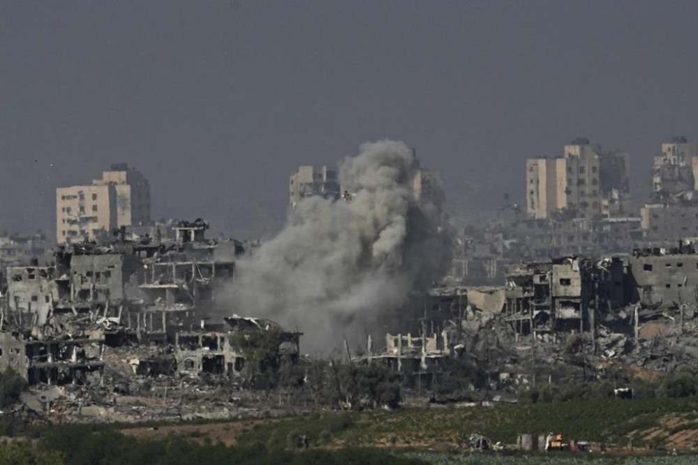 FILE - Smoke rises following an Israeli airstrike in the Gaza Strip, as seen from southern Israel, Tuesday, Oct. 31, 2023. Israel and Hamas have both been accused of breaking the rules of armed conflict. Hamas killed hundreds of civilians and abducted scores more when it attacked southern Israel on Oct. 7. Israel has bombarded Gaza and told more hundreds of thousands of Palestinians to leave their homes. The United Nations says it is collecting evidence of war crimes by all sides. But holding perpetrators to account for is often difficult. (AP Photo/Ariel Schalit, File)