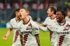 Leverkusen's Alejandro Grimaldo, left, celebrates scoring their side's third goal of the game with teammates during the German Bundesliga soccer match between Bayer Leverkusen and TSG Hoffenheim at PreZero Arena, Sinsheim, Germany, Saturday Nov. 4, 2023. (Uwe Anspach/dpa via AP)