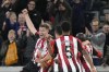 Brentford's Nathan Collins, left, is congratulated by teammates after scoring during the English Premier League soccer match between Brentford and West Ham United at the Brentford Community Stadium, in London, England, Saturday, Nov. 4, 2023. (AP Photo/Alastair Grant)