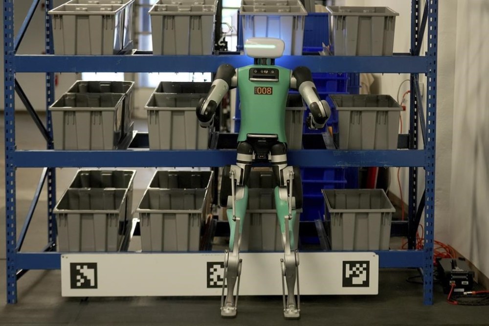 Agility Robotics' robot Digit performs maneuvers at the company's office in Pittsburgh, Wednesday, Aug. 16, 2023. Agility co-founder Jonathan Hurst makes a point of describing Agility's warehouse robot Digit as human-centric, not humanoid, a distinction meant to emphasize what it does over what it's trying to be. (AP Photo/Matt Freed)