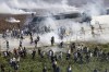 People clash with anti riot Turkish police officers during a pro Palestine protest outside U.S. - Turkish Incirlik military air base in Adana, southern Turkey, Sunday, Nov. 5, 2023. Pro-Islamic Turkish NGO IHH called for people to drive their vehicles in a convoy of demonstrators to gather and protest at U.S. - Turkish Incirlik military air base to show their solidarity with the Palestinians. (AP Photo/Mehmet Sancakzade)