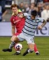 Sporting Kansas City forward Alán Pulido (9) is tripped by St. Louis City defender Tim Parker, left, during the first half of an MLS playoff soccer match, Sunday, Nov. 5, 2023, in Kansas City, Kan. (AP Photo/Colin E. Braley)