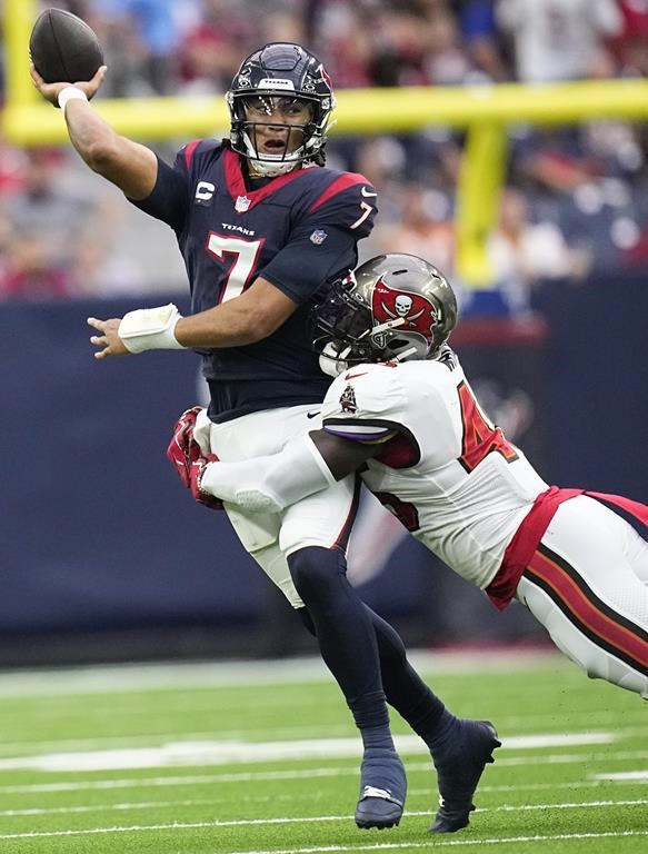 Houston Texans quarterback C.J. Stroud (7) attempts a pass while being hit by Tampa Bay Buccaneers linebacker Devin White during the first half of an NFL football game, Sunday, Nov. 5, 2023, in Houston. (AP Photo/Eric Gay)