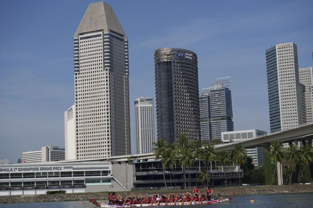 Britain's Prince William, center, participates in a dragon boat event in Singapore, Monday, Nov. 6, 2023. (AP Photo/Vincent Thian)