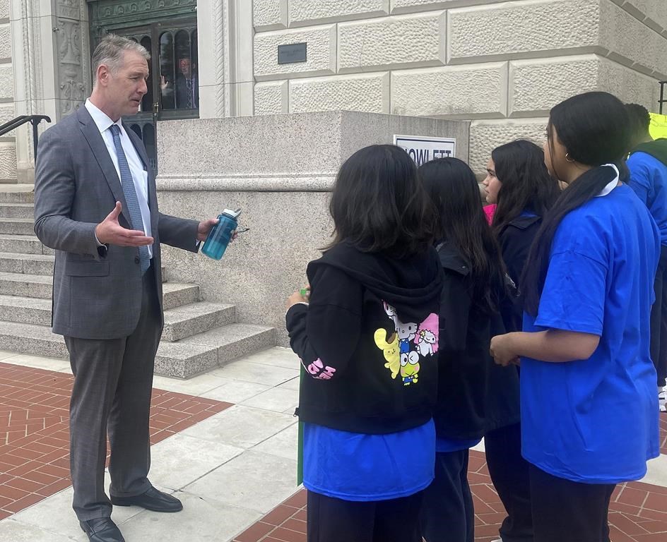 Senate Minority Leader John Curran, R-Downers Grove, addresses a group of protesters outside temporary Senate chambers hoping to convince lawmakers to reinstate the Invest in Kids private school scholarships in this Thursday, Oct. 19, 2023 photo. The five-year-old program expires Dec. 31 and Curran wants to see it extended. Critics led by public school teachers' unions such as Dan Montgomery of the Illinois Federation of Teachers say it drains money from public education. (AP Photo/John O'Connor)