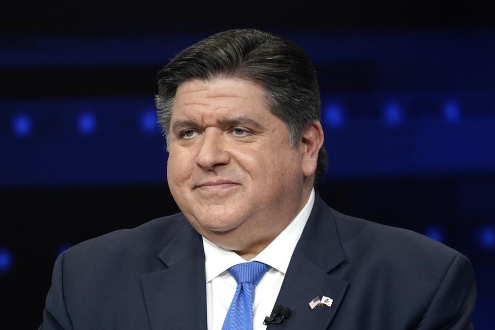 FILE - Illinois Gov. JB Pritzker participates in a debate with Republican gubernatorial challenger, state Sen. Darren Bailey, at the WGN9 studios, Oct. 18, 2022, in Chicago. The Invest in Kids private school scholarship program expires Dec. 31, 2023, and proponents want to extend it. Critics such as public school teachers' unions say it takes money away from public education. Pritzker says he wants to see money go toward public schools but is willing to sign legislation to reauthorize the $75 million scholarship program. (AP Photo/Charles Rex Arbogast, File)