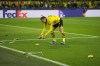 Dortmund's Nico Schlotterbeck cleans the pitch after throwing from spectators during the Champions League Group F soccer match between Borussia Dortmund and Newcastle United in Dortmund, Germany, Tuesday, Nov. 7, 2023. (AP Photo/Martin Meissner)