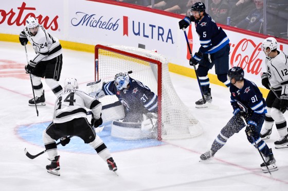 Los Angeles Kings' Arthur Kaliyev (34) scores on Winnipeg Jets goaltender Connor Hellebuyck (37) during third period NHL action in Winnipeg on Tuesday. (Fred Greenslade / The Canadian Press)