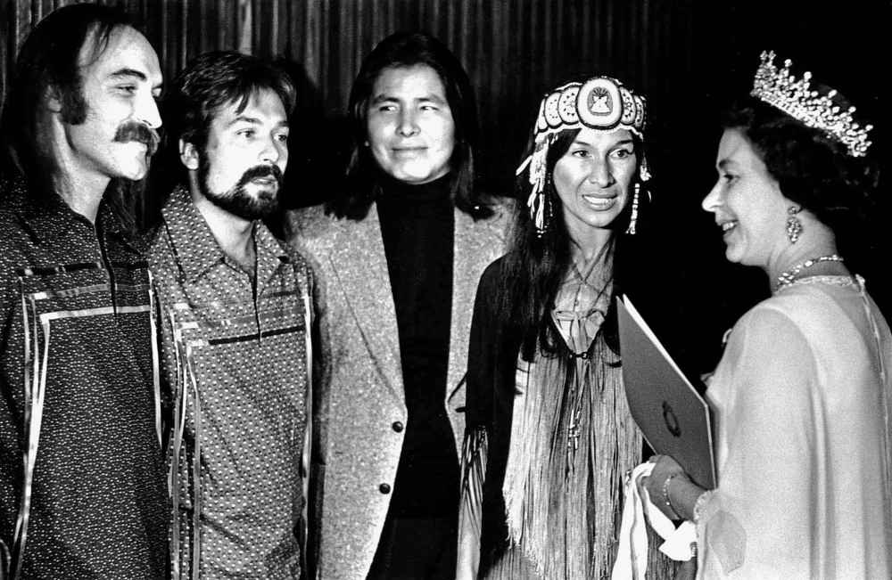 Queen Elizabeth II (right) talks with Buffy Sainte-Marie (second from right) and members of her band after their royal concert at Ottawa's National Arts Centre, Oct. 16, 1977. (CP PHOTO)