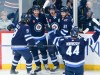 Winnipeg Jets' Alex Iafallo (9), Gabriel Vilardi (13), Mark Scheifele (55), Kyle Connor (81) and Josh Morrissey (44) celebrate ScheifeleÕs goal against the Florida Panthers during first period NHL action in Winnipeg on Saturday, October 14, 2023. THE CANADIAN PRESS/John Woods