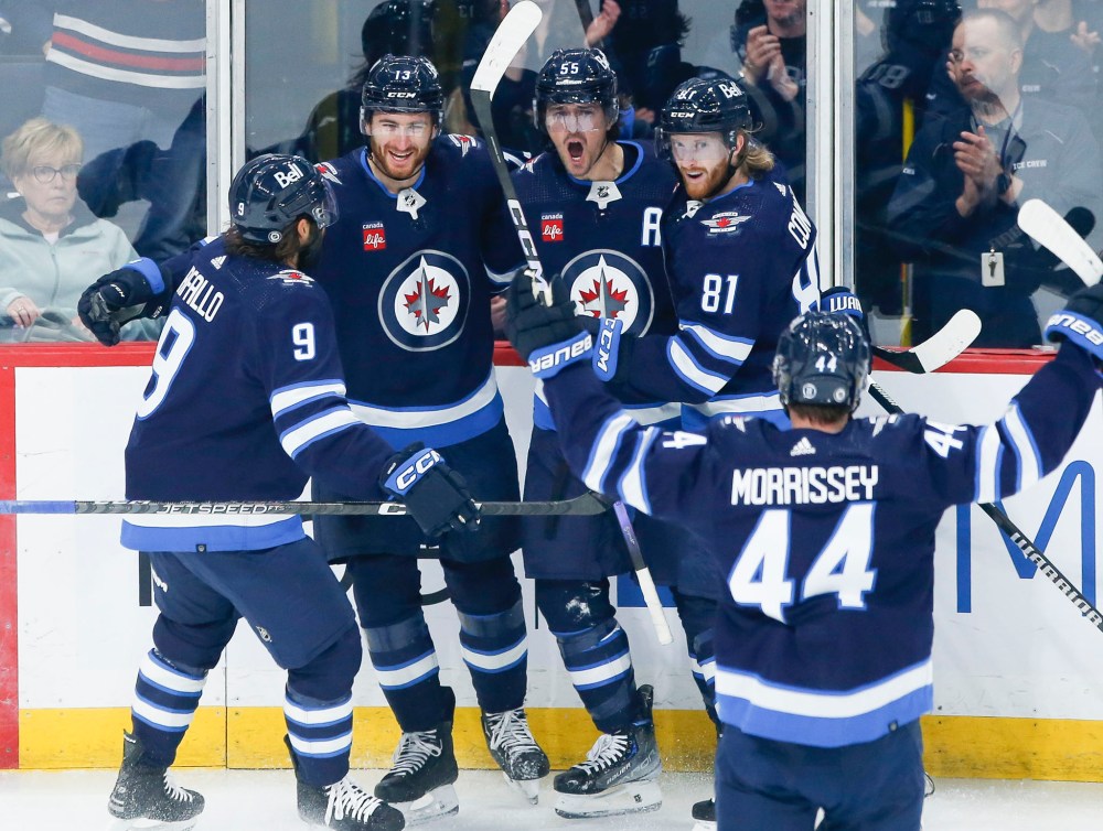 Alex Iafallo, Gabriel Vilardi, Mark Scheifele, Kyle Connor and Josh Morrissey celebrate Scheifele's goal against the Florida Panthers in the first period. (John Woods / The Canadian Press)