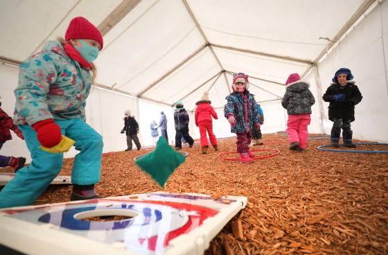 Kindergarten students from École Sage Creek School taking part in gym class inside tents set up on the school grounds. (Ruth Bonneville / Winnipeg Free Press)