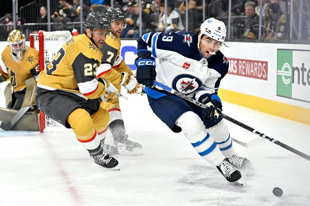 (AP Photo/David Becker)
Winnipeg Jets left wing Alex Iafallo controls the puck against Vegas Golden Knights defencemen Alec Martinez (23) and Alex Pietrangelo (7) during the first period Thursday, in Las Vegas.