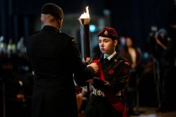The passing of the torch during Remembrance Day Ceremonies in Winnipeg, Saturday, Nov. 11, 2023. (Aaron Vincent Elkaim / The Canadian Press)